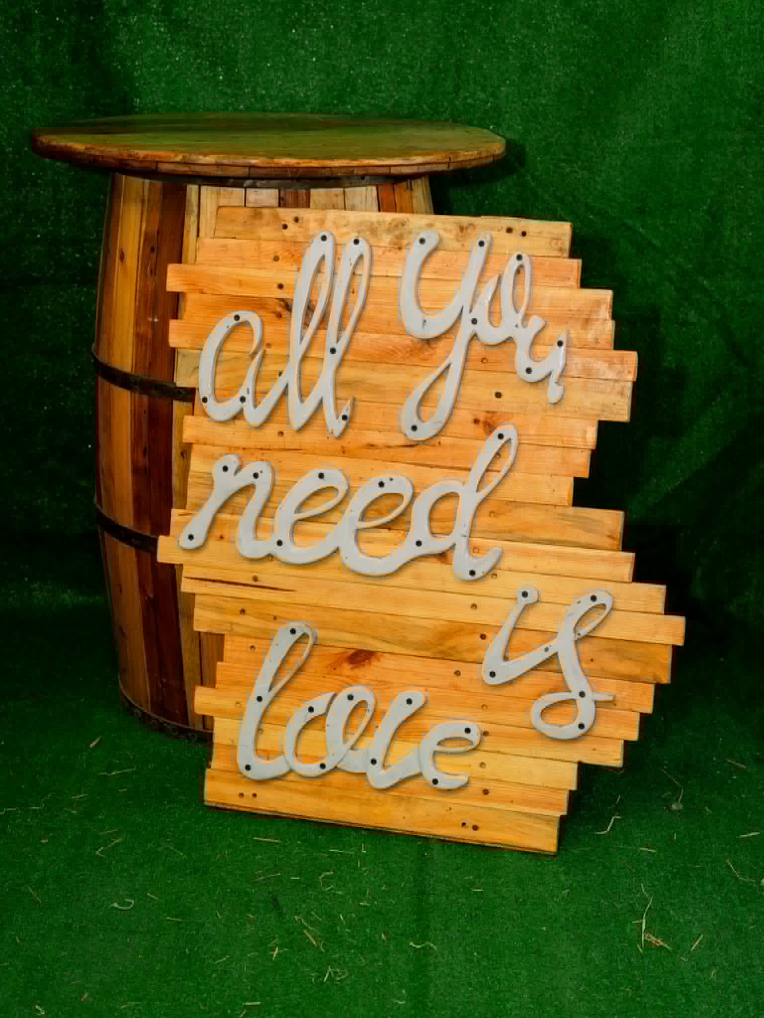 Rustic wood sign reading All you need is love
