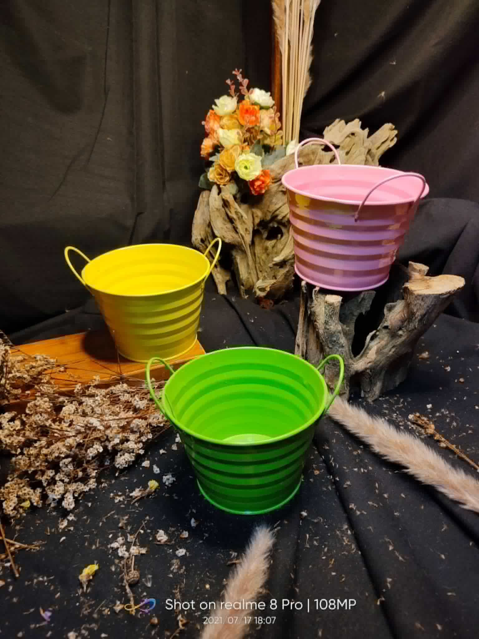 Bright green, yellow, and purple ribbed metal pails