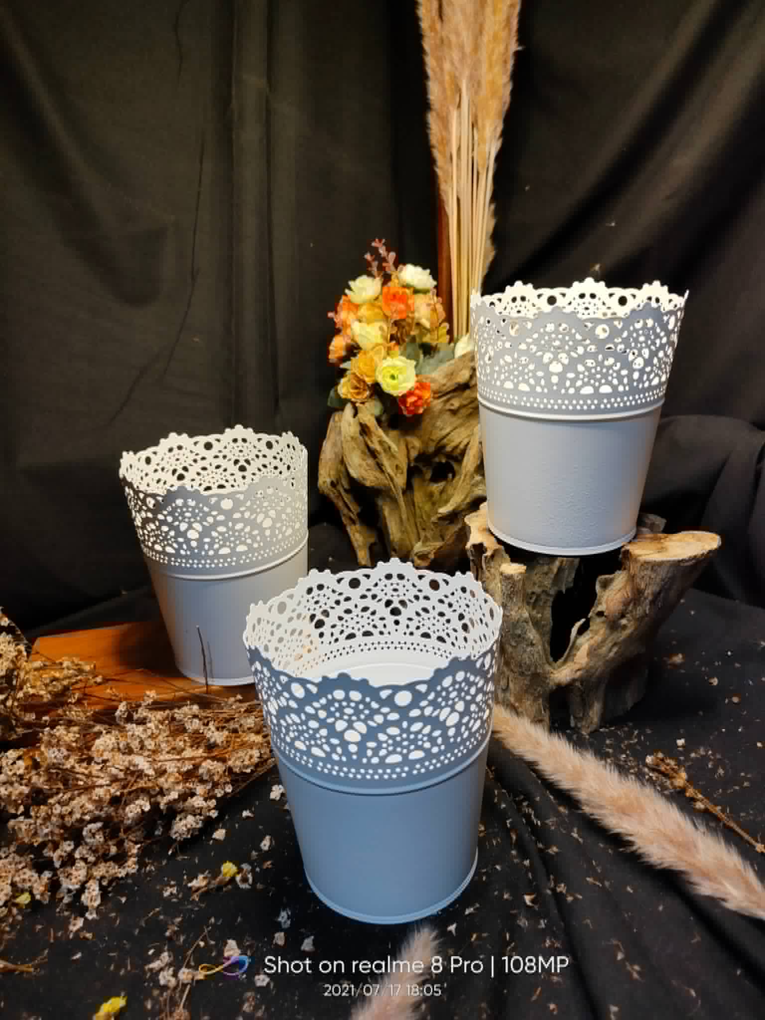 Three white and gray metal pails with lace-cut decorative rims