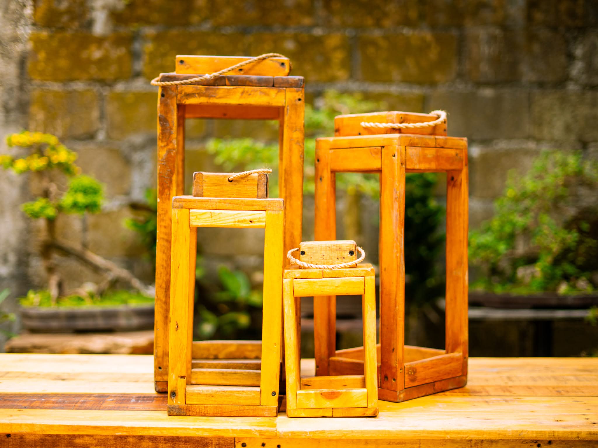 Set of rustic wooden lanterns with rope handles