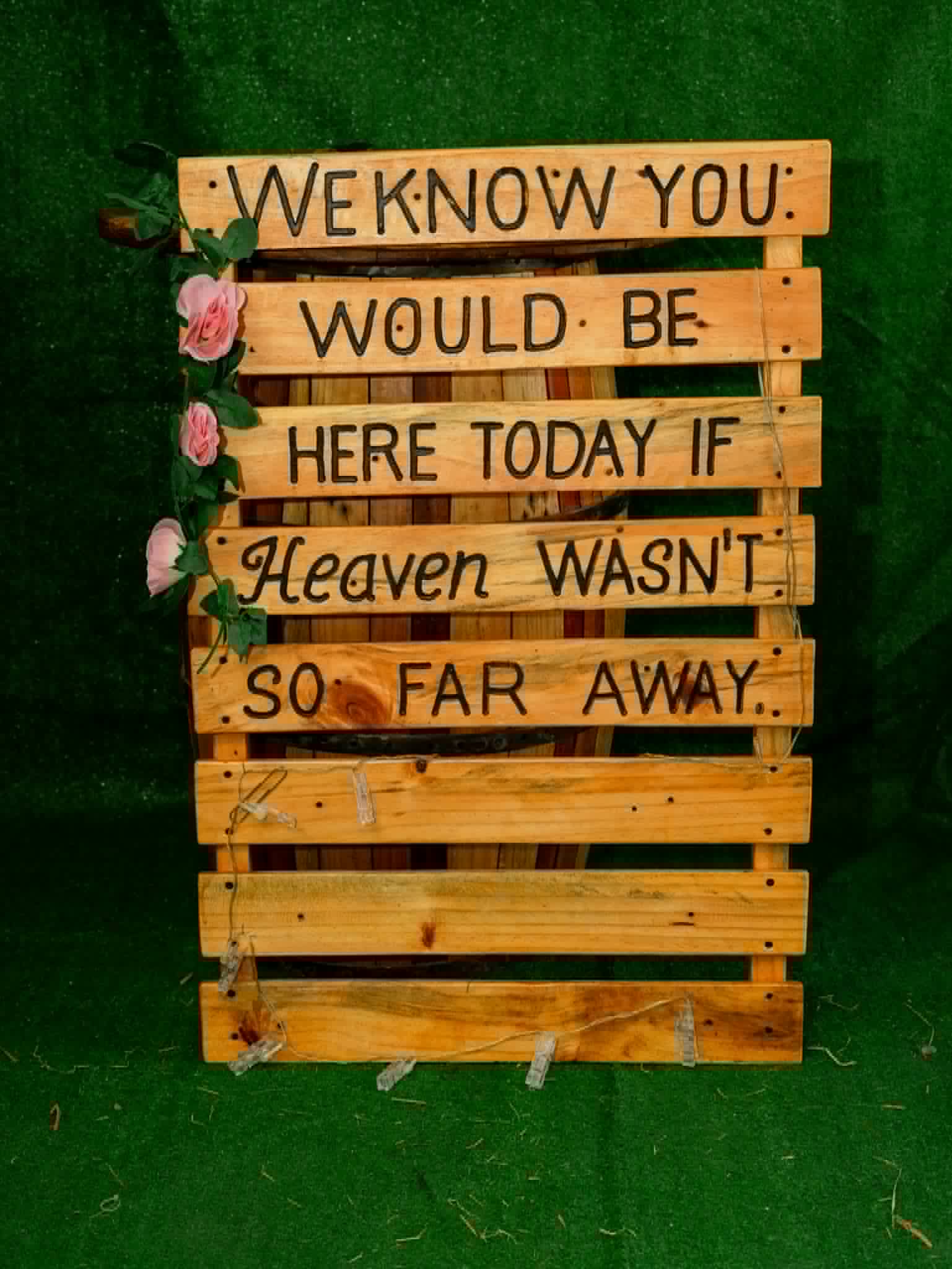 Rustic memorial pallet sign with flowers and remembrance message