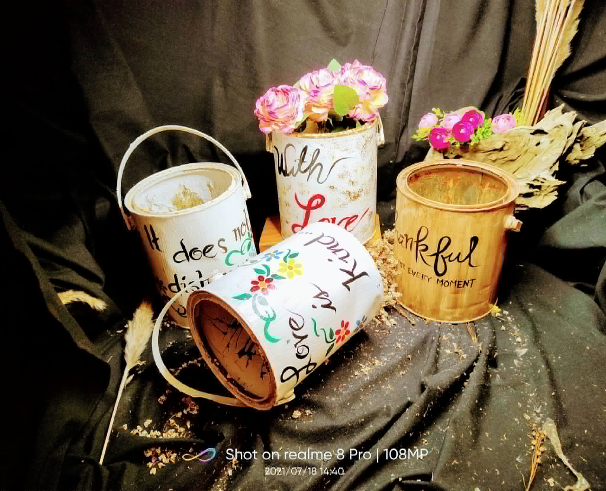 Printed decorative metal pails filled with flowers