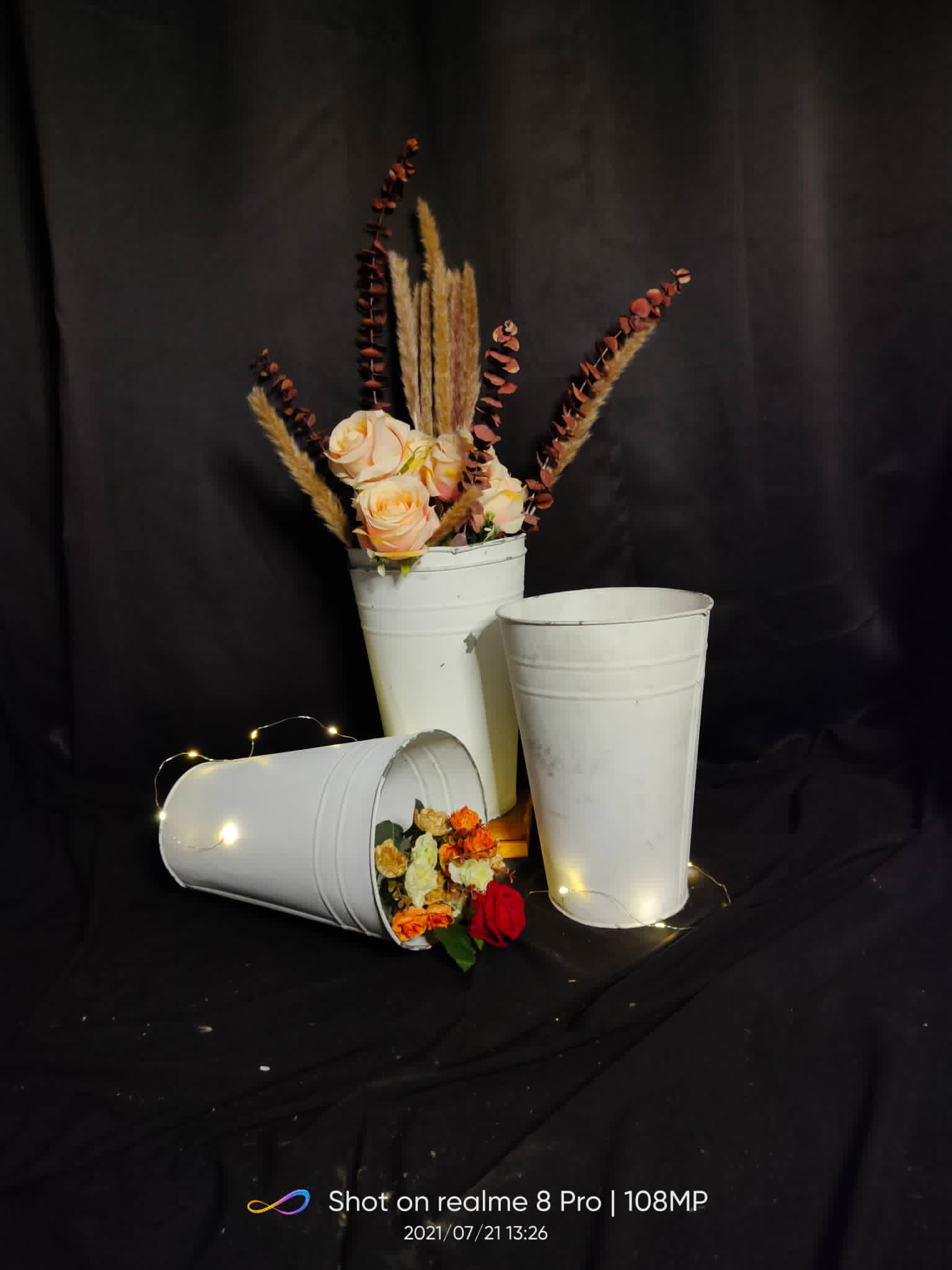 Small white metal pails in assorted sizes with floral accents