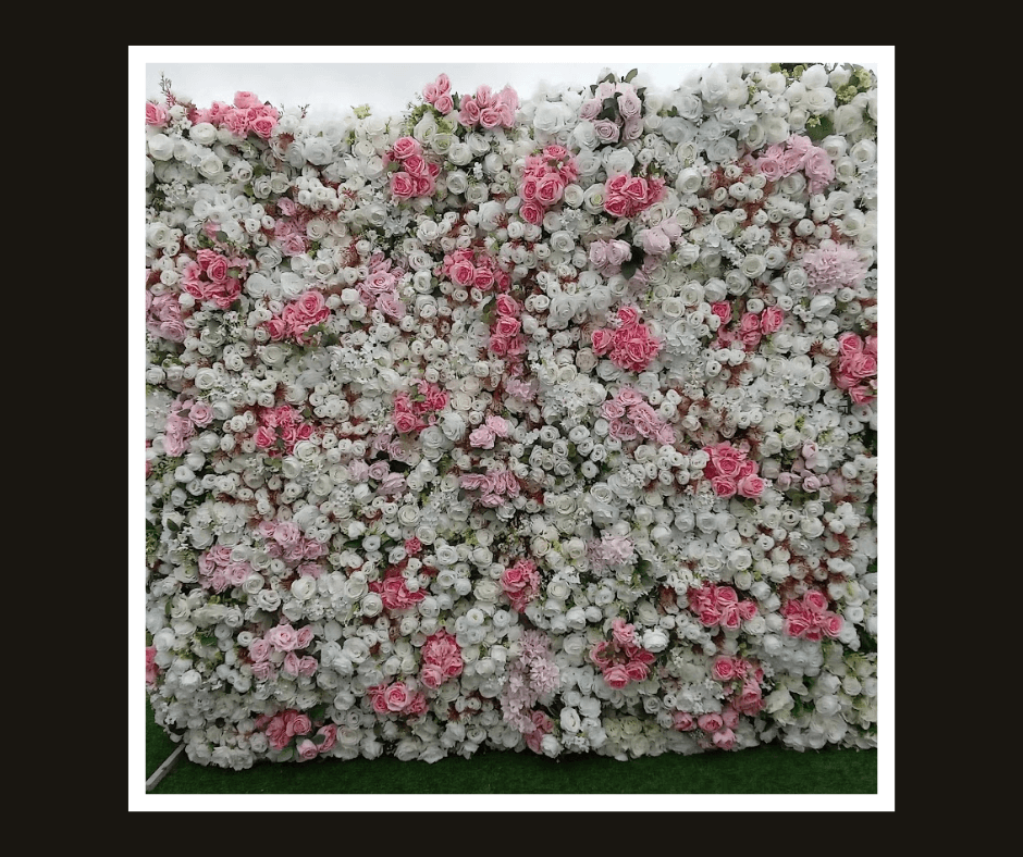 Dense flower wall panel blending white blossoms with scattered blush and pink flowers