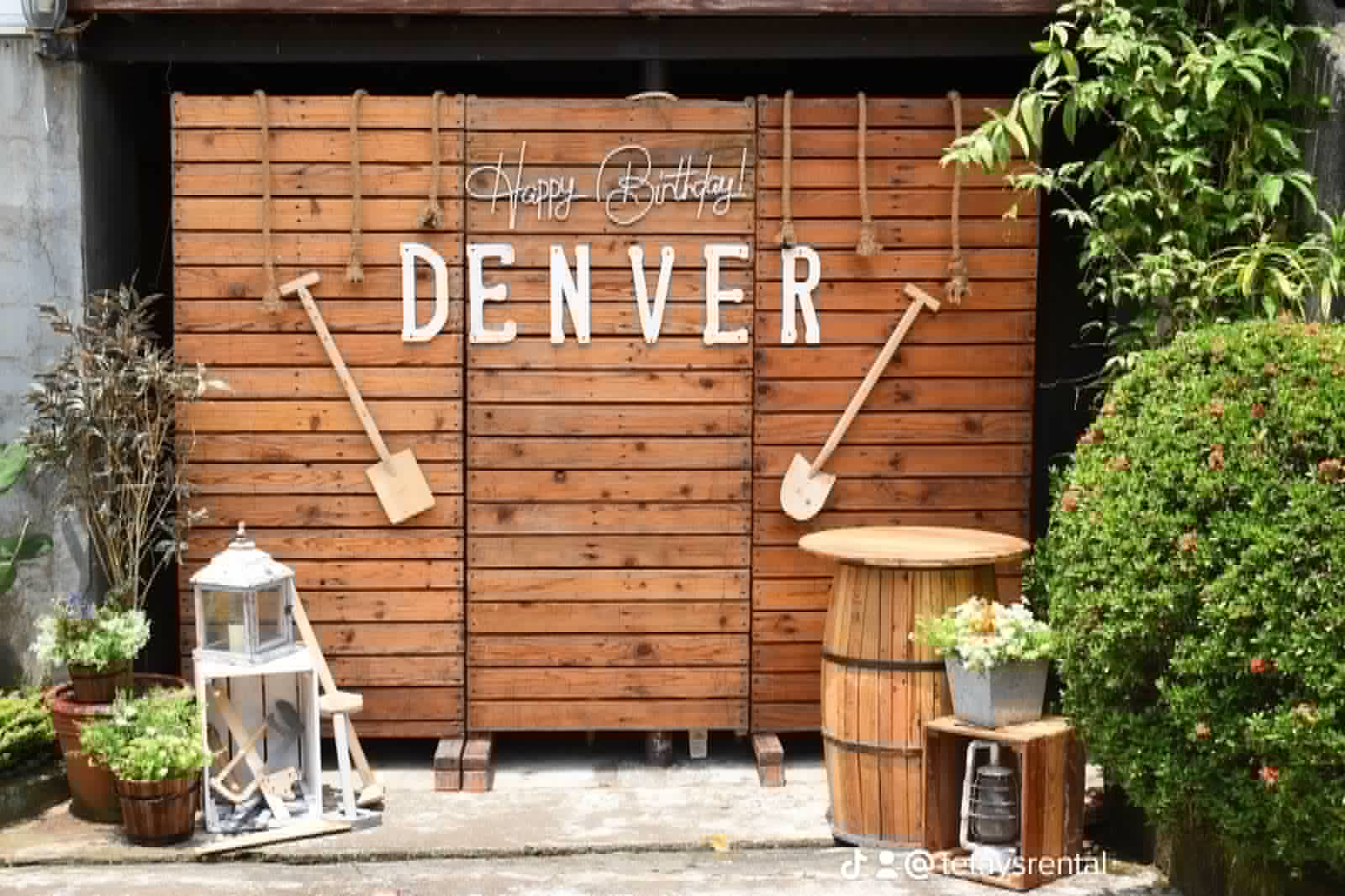 Denver-themed western wood wall with paddles, barrels, lanterns, and rustic props