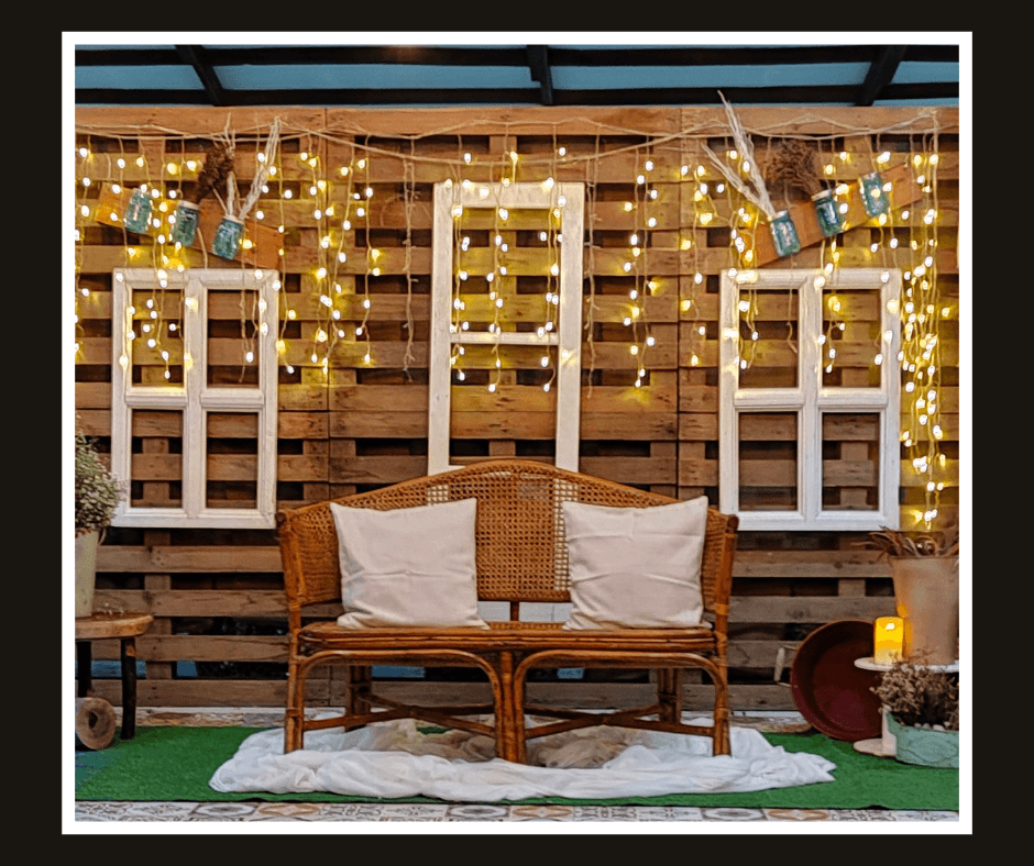 Rustic timber wall with illuminated white window frames and a woven loveseat