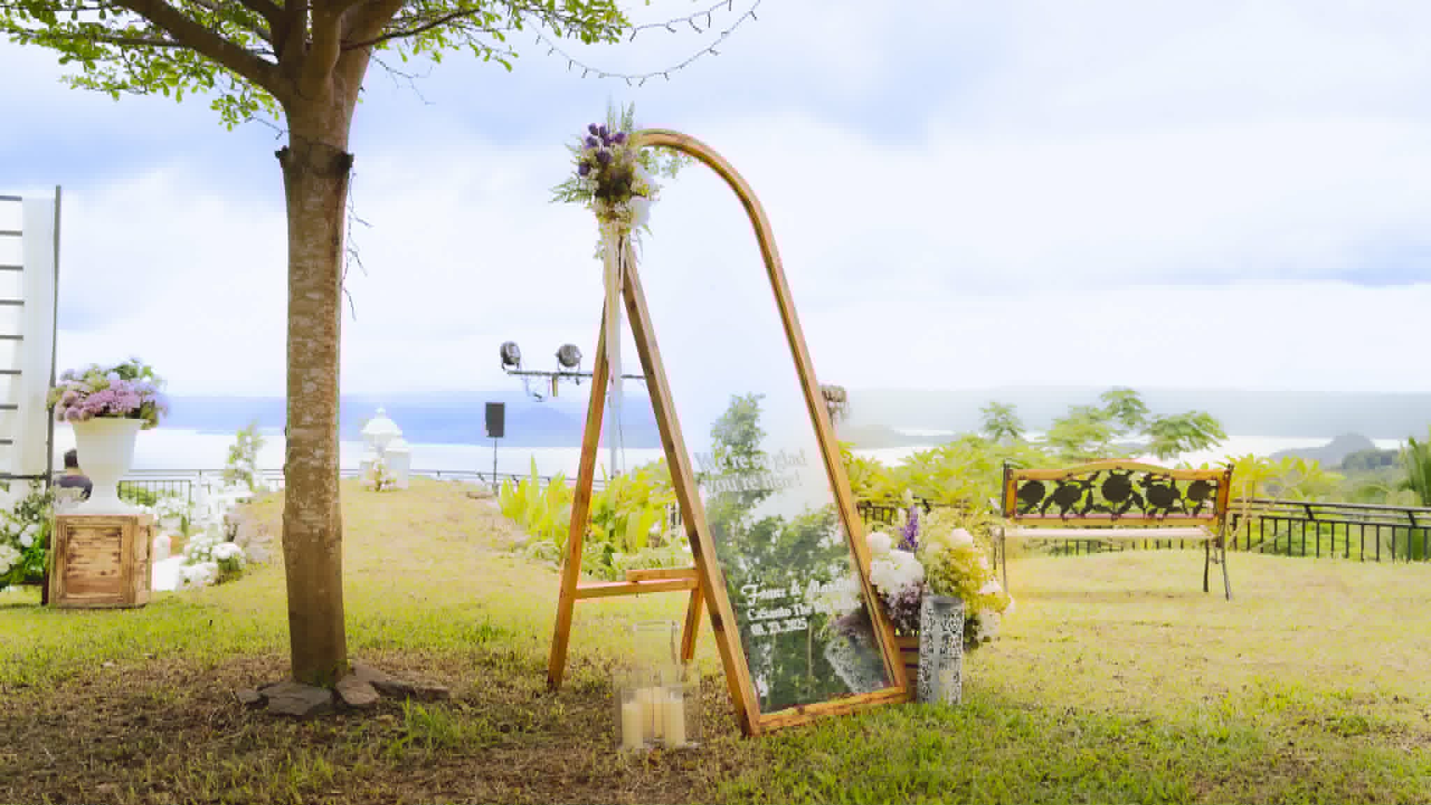 Freestanding full-length mirror in a natural wood frame decorated with flowers