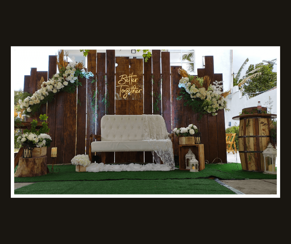 Rustic plank wall with floral corners, hanging bulbs, and a white bench