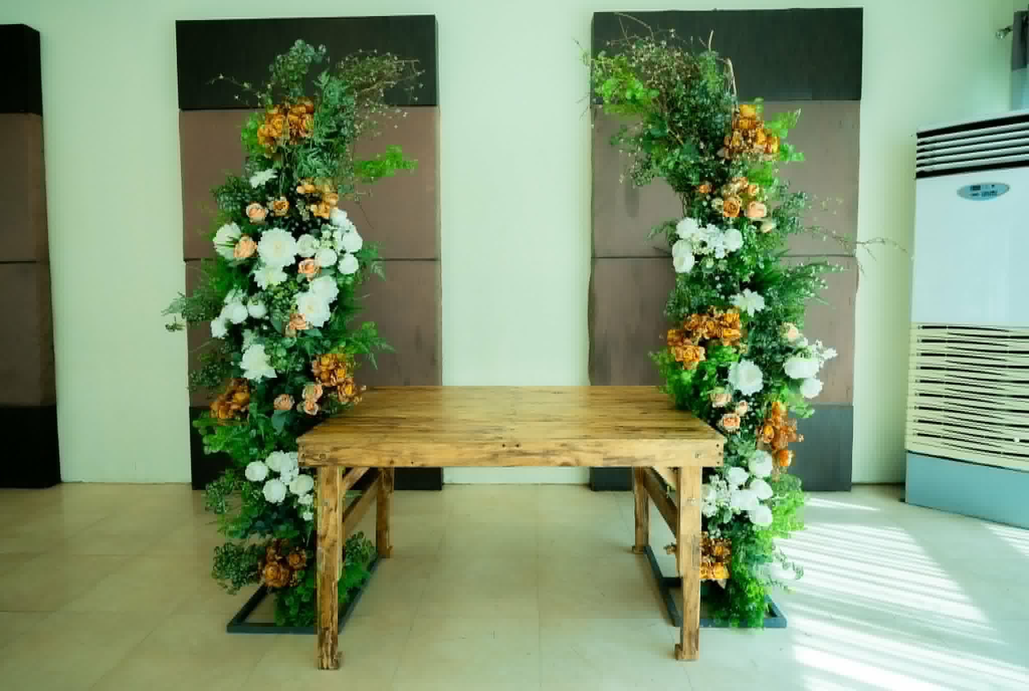 Twin dark panels with colorful floral columns and a rustic wooden bench