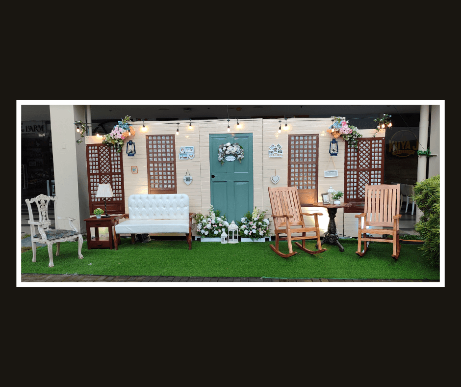 Wide vintage lounge backdrop with mismatched doors, window panels, flowers, and seating