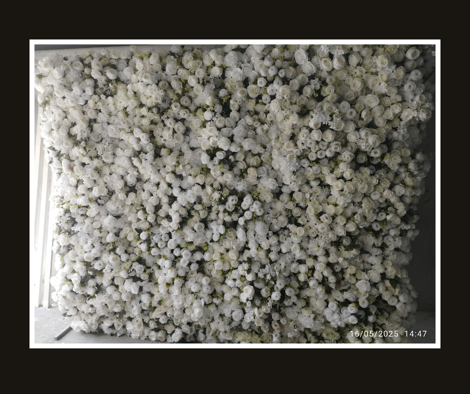 Dense white baby’s breath flower wall with soft gray-green foliage
