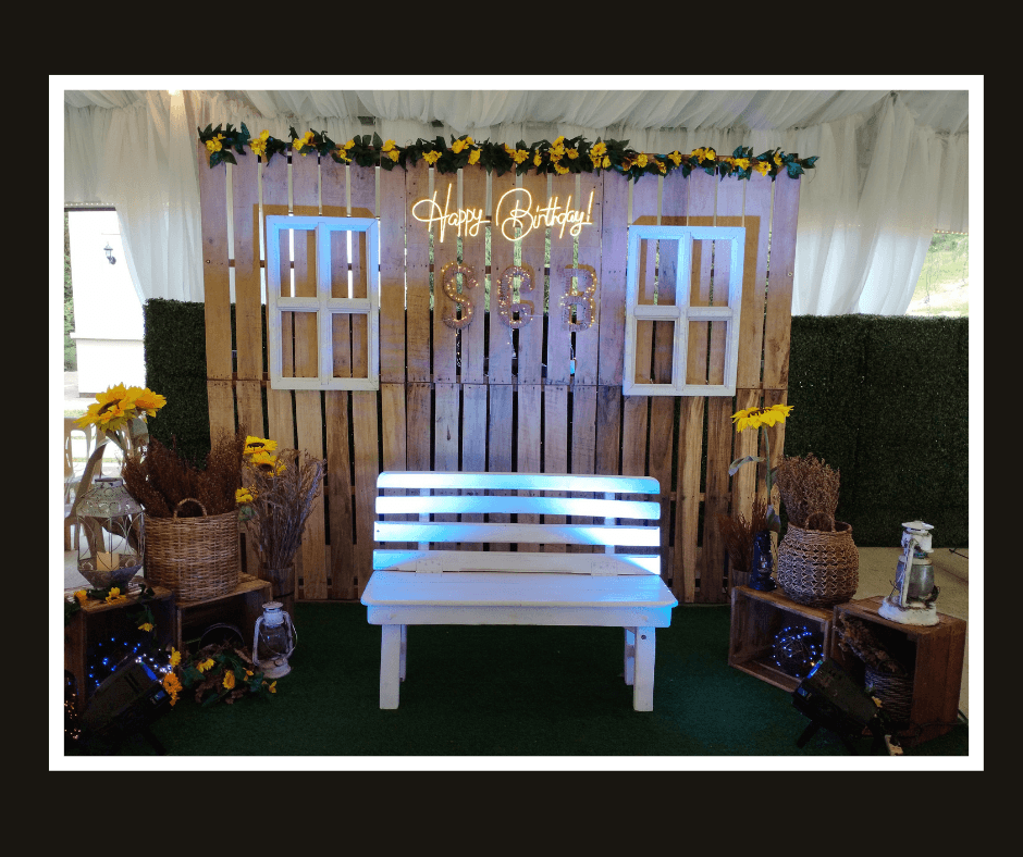 Dark rustic lounge backdrop with white window frames, a plank center panel, and a white bench