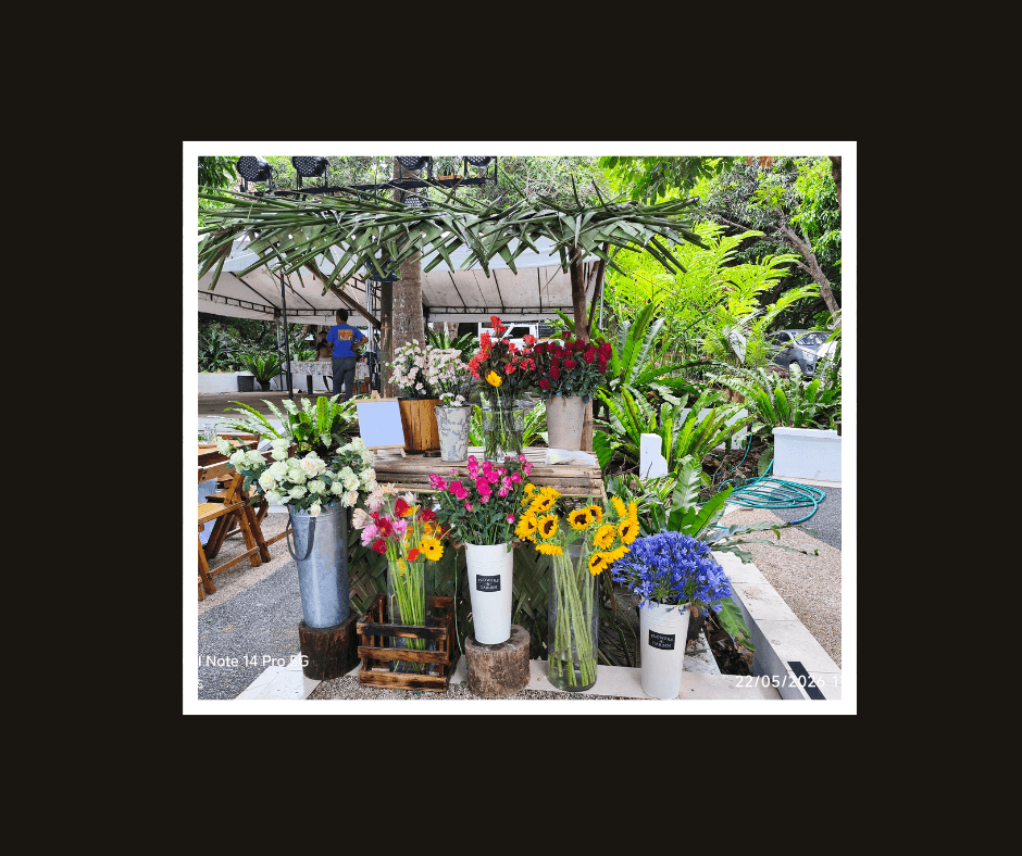 Colorful flower market display with buckets of assorted blooms