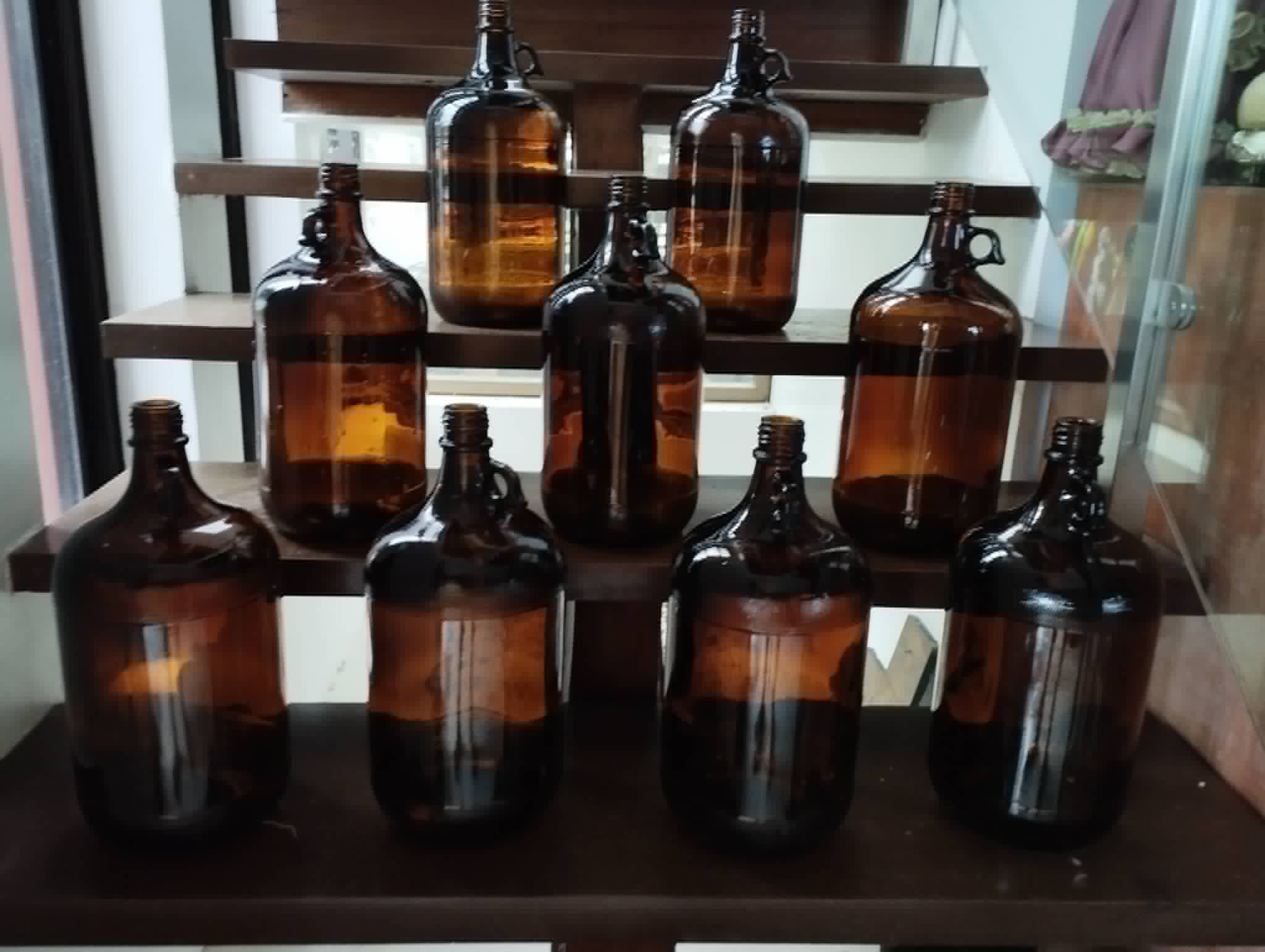 Collection of amber glass bottles in assorted shapes and sizes