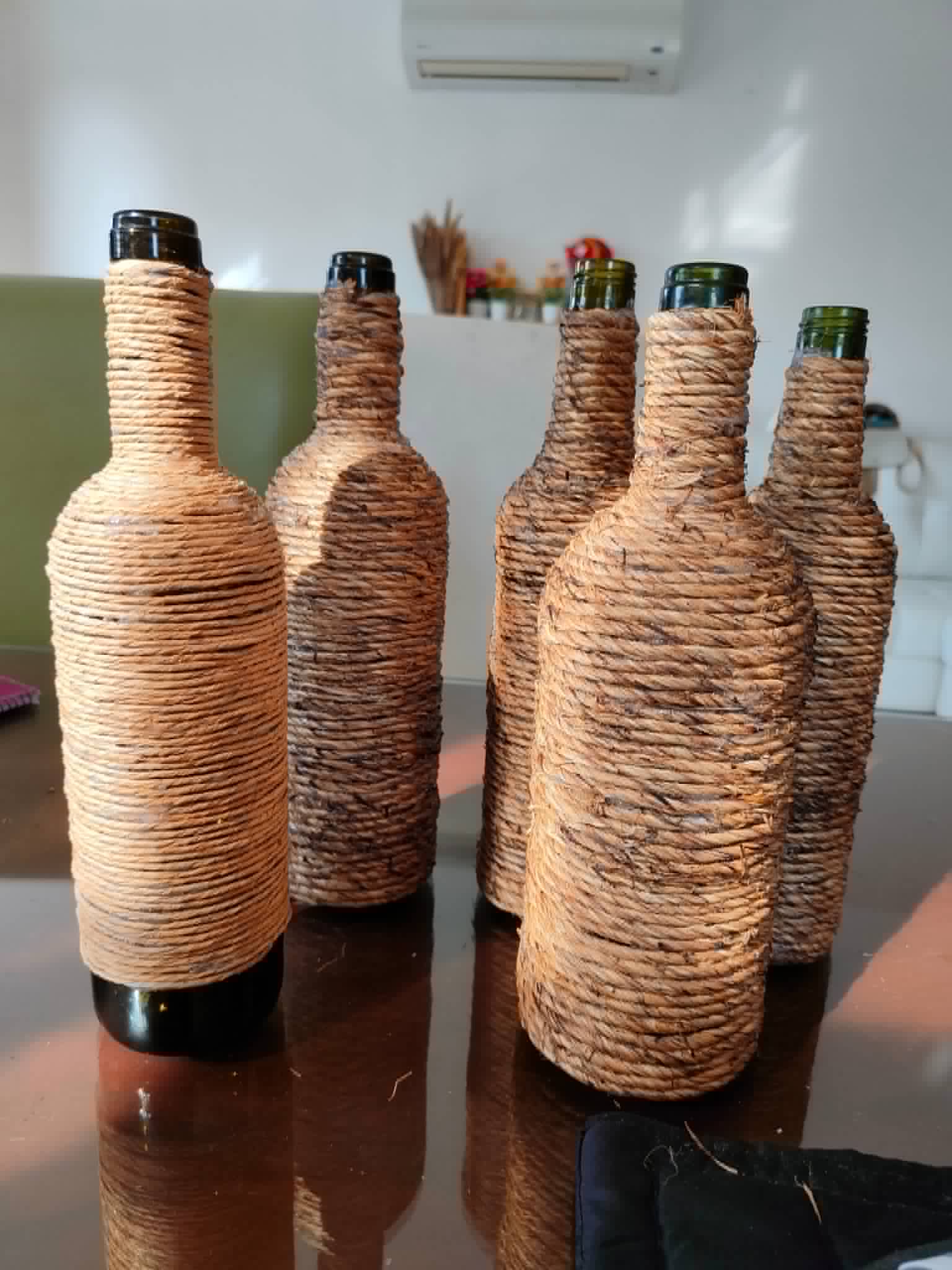 Collection of decorative bottles wrapped in natural twine