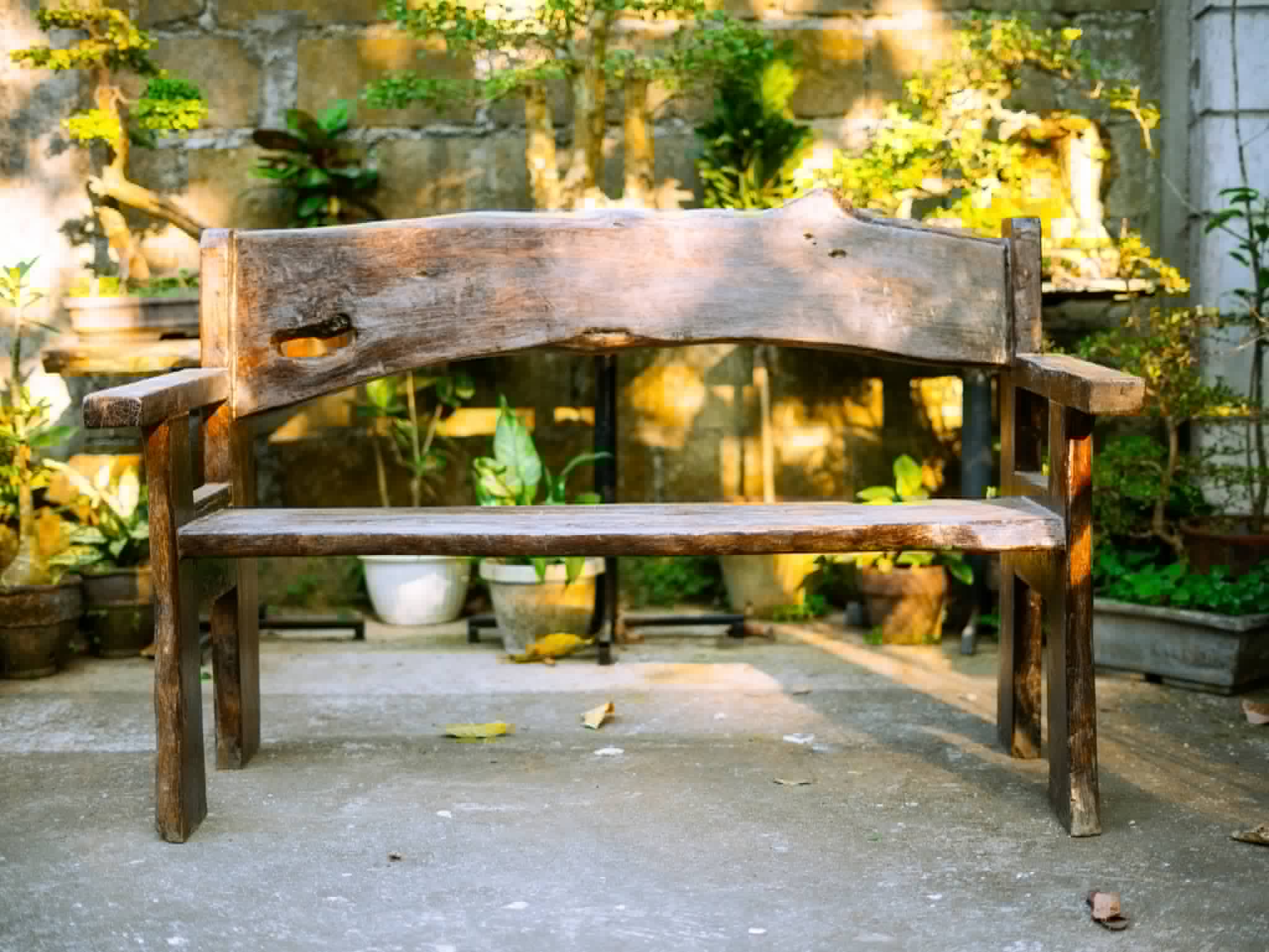 Rustic wooden sweetheart bench with a curved backrest