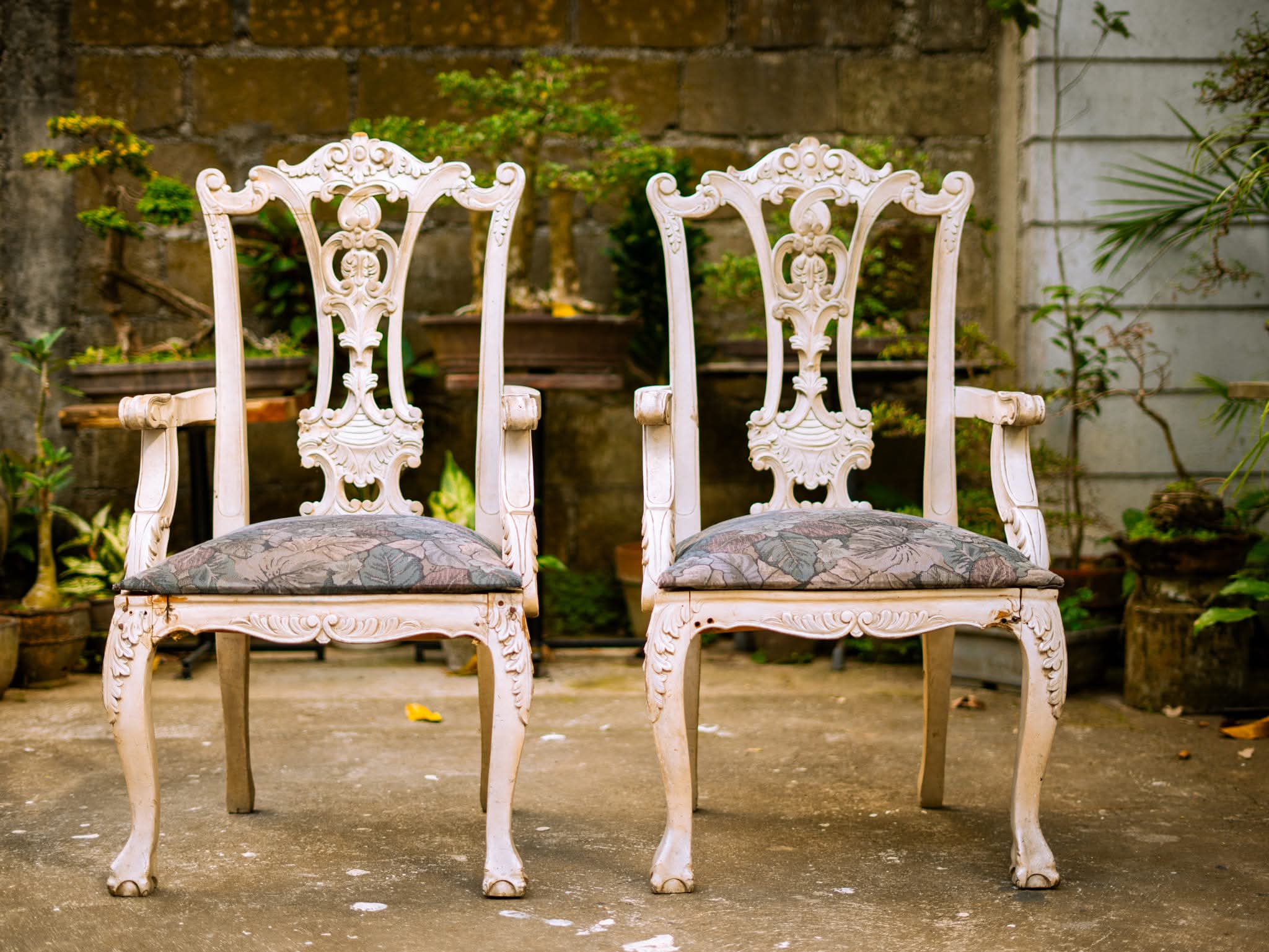 Pair of ornate carved white statement armchairs