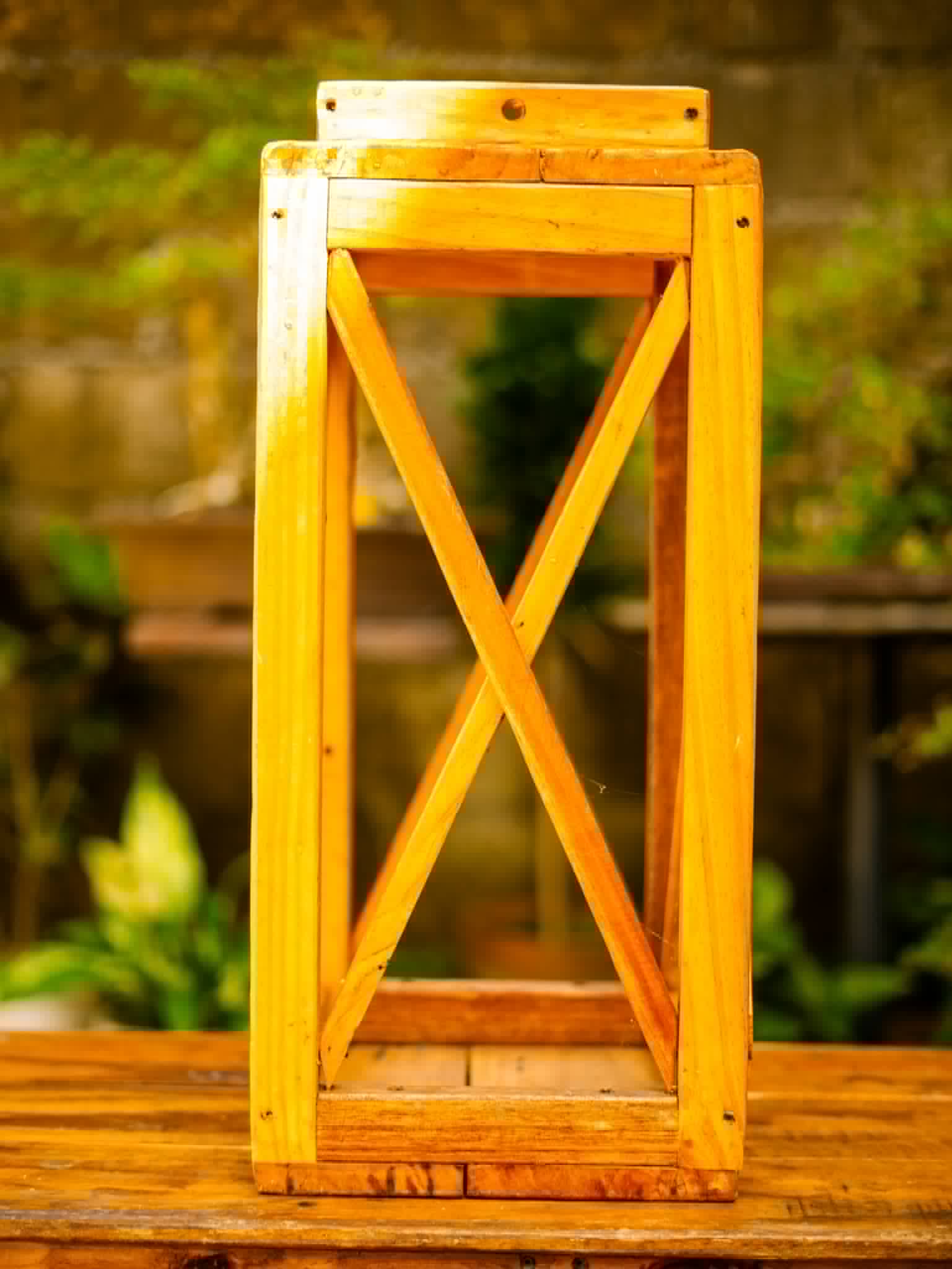 Tall natural wood lantern with glass panels