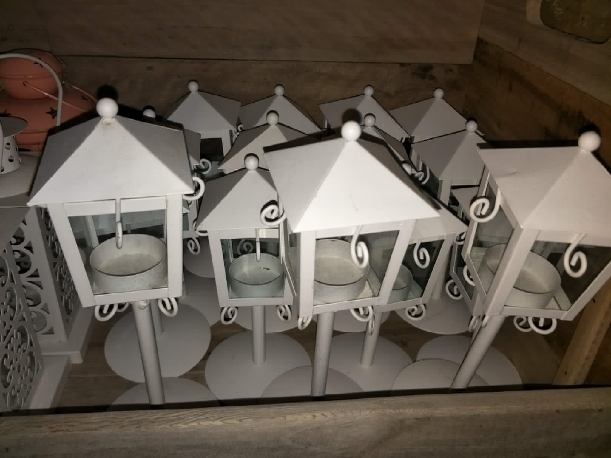 Collection of white square hanging lanterns with curled metal hooks