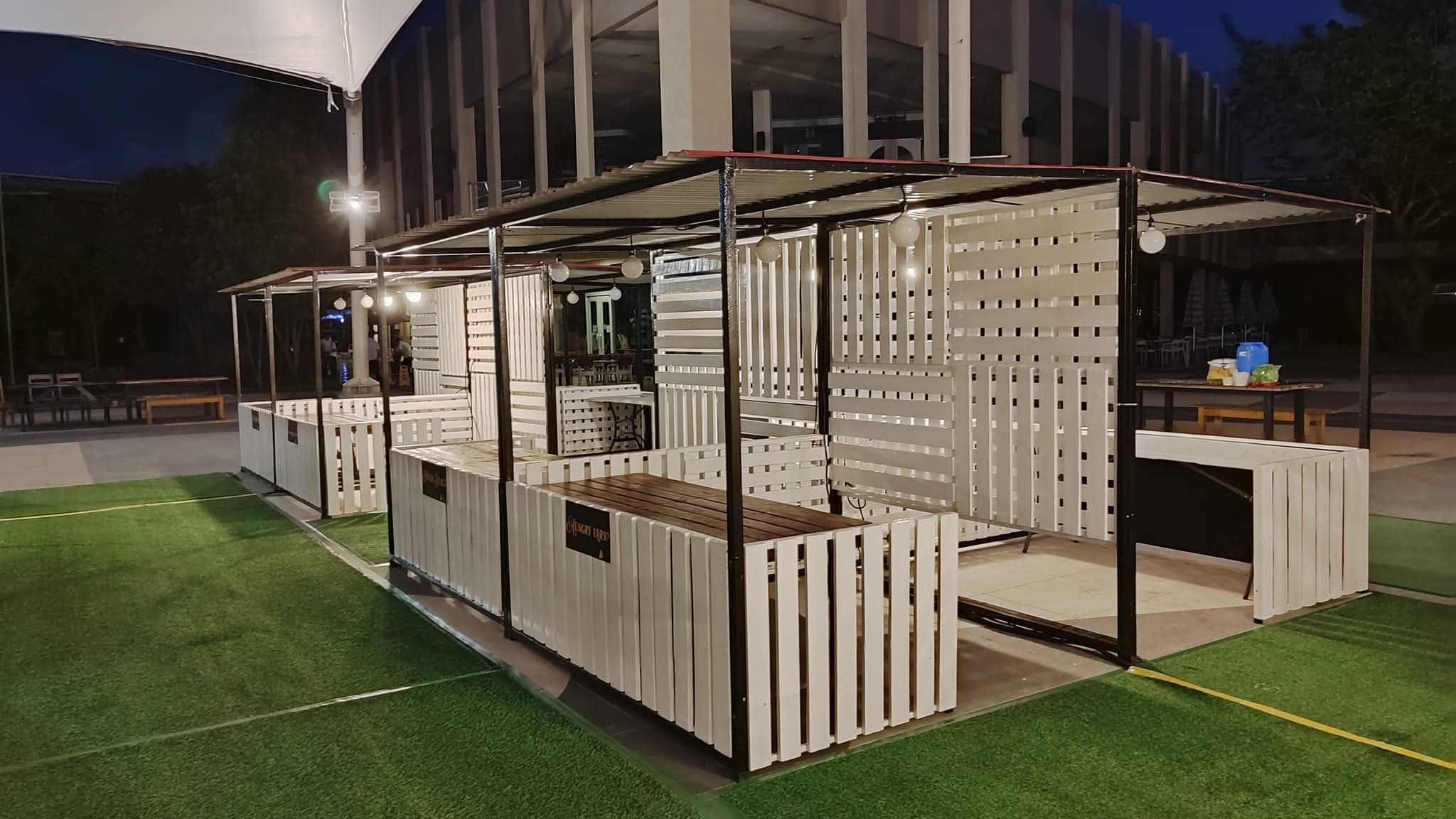 Custom white pallet booths and counters built for an outdoor bazaar
