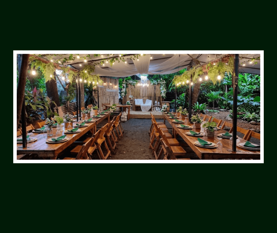 Long garden banquet table beneath a decorated marquee